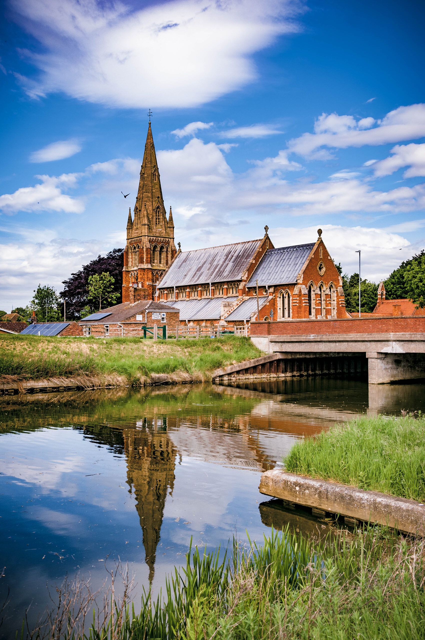 St Paul’s Church, Spalding, Lincolnshire with reflection St Paul's Church, Fulney, Spalding, Lincolnshire, UK with reflection in the Coronation Channel against a fair weather sky