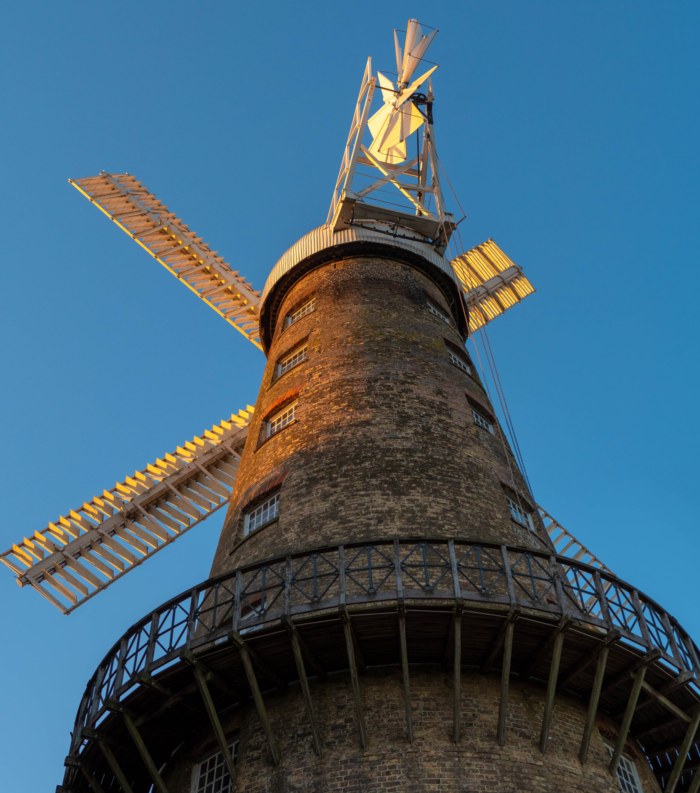 Moulton Windmill at Golden Hour, low angle Moulton Windmill, near Spalding in Lincolnshire in low summer sun at golden hour under a clear blue sky