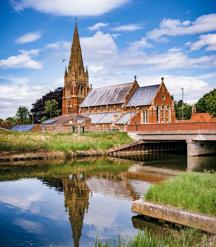 St Paul’s Church, Spalding, Lincolnshire with reflection St Paul's Church, Fulney, Spalding, Lincolnshire, UK with reflection in the Coronation Channel against a fair weather sky